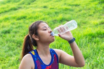 woman beautiful asian drinking water after jogging running outdoor.Healthy and Lifestyle concept.