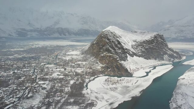 Drone shot of snow covered landscape of hills and rivers in Skardu city, Pakistan.