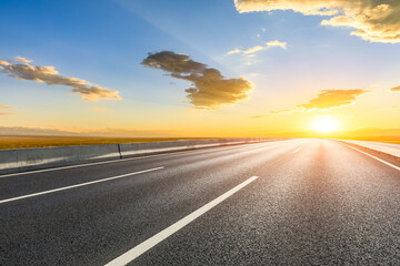 Asphalt highway road with sky clouds at sunset