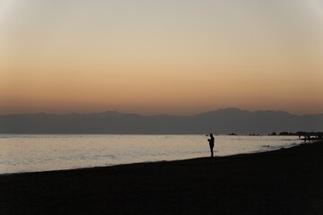 Silhouette of a fisherman on a seashore at sunset in Turkey
