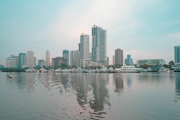 Fototapeta na wymiar Calm waters of the sea with the buildings of Manila City of the Philippines in the background