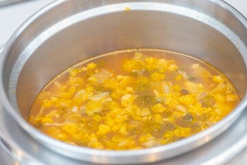 Closeup shot of a tasty and hot soup in the big pot
