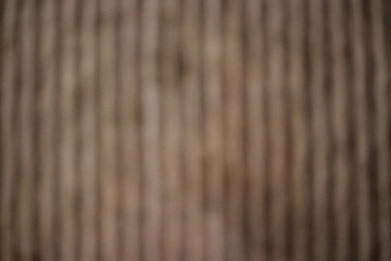 A blurry dreamy view of brown vertical lines.