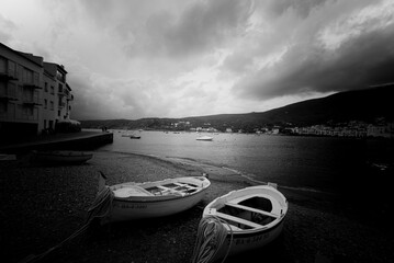 Grayscale shot of boats parked on a shore