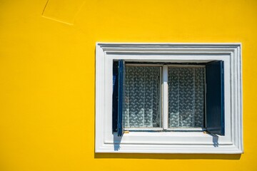 Beautiful shot of a window on a yellow wall background