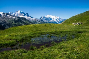 Fototapeta premium Landscape of wet grass hills and houses in charamillon gondola alps in Haute Savoie, France