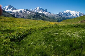 Fototapeta premium Landscape scene of green hills in charamillon gondola snowy alps in Haute Savoie, France
