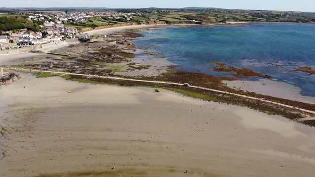 Drone view of the Marazion beach and town near St Michael's Mount during the daytime in Cornwall, UK