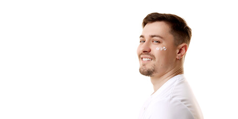 Banner. Profile view portrait of young man with facial care cream patches against white studio background with negative space. Concept of natural beauty, male health, anti-aging, procedures, cosmetic.