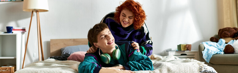 alluring red haired woman lying in bed next to her loving boyfriend with headphones at home, banner