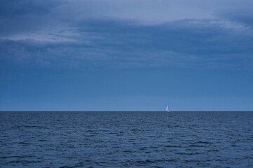 Lonely sailboat in the sea at a stormy weather
