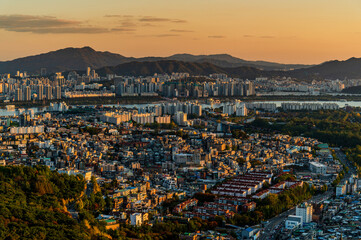Gold sun risae or sunset of Seoul cityscapes with high rise office buildings and skyscrapers in...