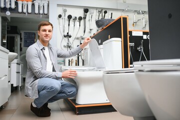 Man choosing home toilet in store