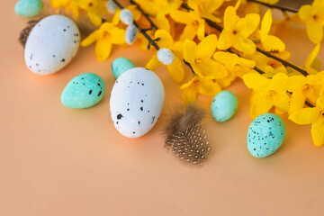 Composition of flowers and Easter eggs on a pastel background