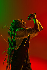 Emotive man, soulful musician with dreadlocks expressing his deepest emotions through his singing...
