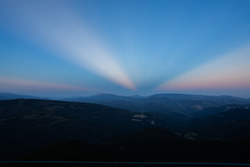 Sunset with anticrepuscular rays in the Sierra del Cadi, Pyrenees, Spain - obrazy, fototapety, plakaty