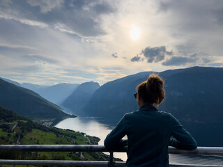 Fototapeta na wymiar Young woman in Stegastein view point road, south Norway. Europe
