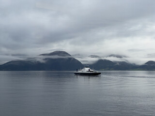 A scene of a ferry on a rainy day crossing the Sogn Fjord, Norway
