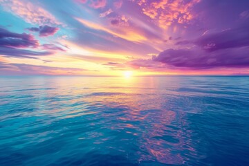 Obraz premium Aerial view of a vibrant sunset over the ocean, painting the sky with streaks of orange, purple, and pink