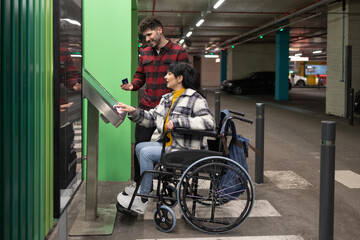 Woman in wheelchair and men paying in underground car parking