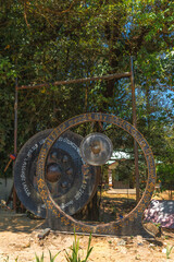 A large metal circle with a bell on top of it