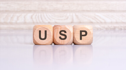 concept of USP word on wooden cubes, wooden background