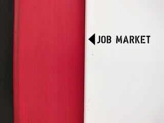 On red wall sign direction to JOB MARKET - Where individuals search for job opportunities and...