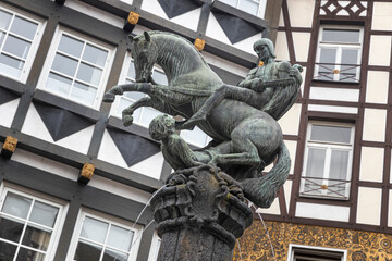 Historic  fountain. Statue of the holy Martin, Cochem, Holy Saint-Martin-Statue Moselle. Half...