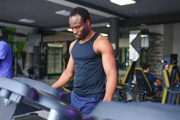 Fototapeta na wymiar Sports, fitness, healthy lifestyle. African man in the gym.
