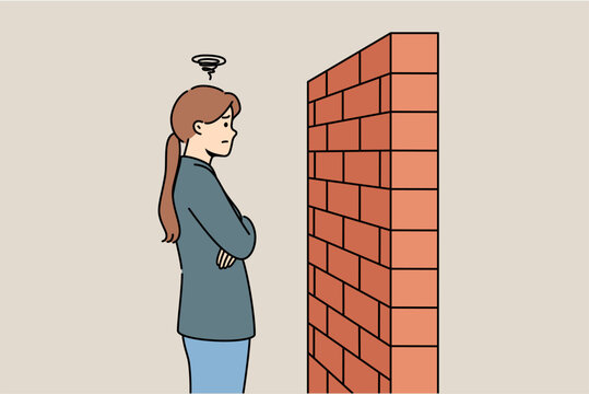 Woman stands near brick barrier, as concept of insurmountable obstacle when trying to solve problems. Obstacle on path of person moving forward and wanting to achieve goals or accomplish plans