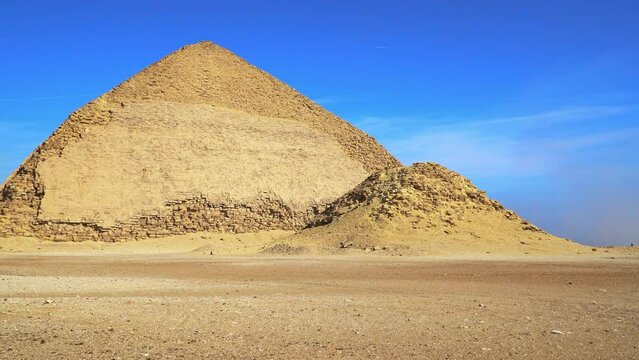 The Bent Pyramid is an ancient Egyptian pyramid located at the royal necropolis of Dahshur, approximately 40 kilometres south of Cairo, built under the Old Kingdom Pharaoh Sneferu. Egypt