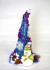 Green Christmas tree with decorations and snowman on a white background. Festive Christmas...