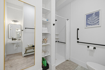 a bathroom with all white and has a sink and mirror