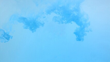 Blue color dye melt on white background,Abstract smoke pattern,Colored liquid dye,Splash paint