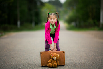 Childhood Exploration. With her colorful outfit, suitcase, and cuddly toy, the girl explores the world around her, eager for new experiences.