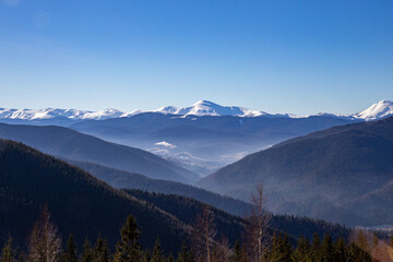 the mountains in spring, the high peaks are still covered with snow when spring comes to the valleys
