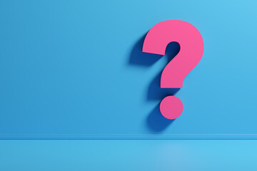 Question mark symbol on a blue wall with copy space.