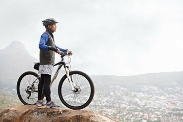 Fitness, nature and a man on a mountain with a bike for training, workout and exercise. Morning,...