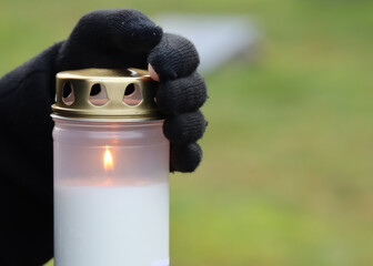 A freshly lit grave candle