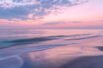 A serene beach featuring water and sand, providing a tranquil environment, A serene beach at dawn...