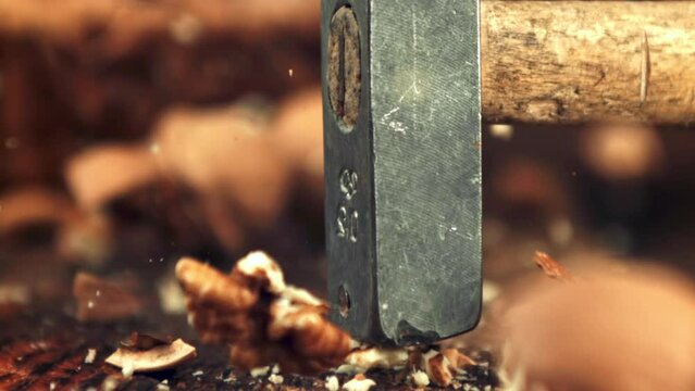 Super slow motion of the nut is stabbed with a hammer.Filmed on a high-speed camera at 1000 fps. High quality FullHD footage