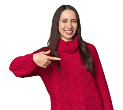 Young Caucasian woman in cozy red sweater on studio background person pointing by hand to a shirt copy space, proud and confident - Powered by Adobe