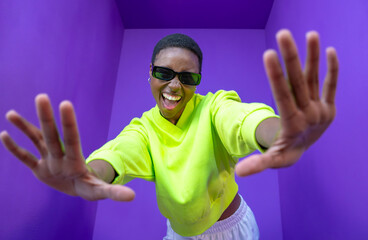 Young black woman doing frame using hands and fingers, isolated over purple background. High quality photo