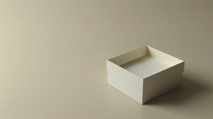 Empty white open box of square shape on a flat surface, emphasized by a shadow