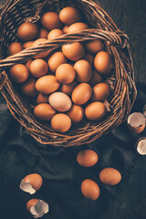 Fresh organic eggs from farm in a basket placed on wooden table