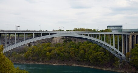 Bridge at US-Canada border in Niagara Falls. Border connects, units, and divides. Scenic border crossing, embodying peace, and cooperation. Cinematic shot of Neagar Bridge from Canada to the USA