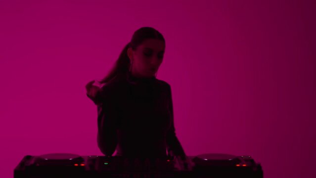Beautiful Brunette Woman Standing Behind Modern DJ Controller, Female DJ Playing Electronic Music