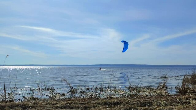 A young man is engaged in kiteboarding