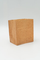 Brown paper bag on white background - 779697459