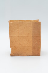 Brown paper bag on white background - 779697646